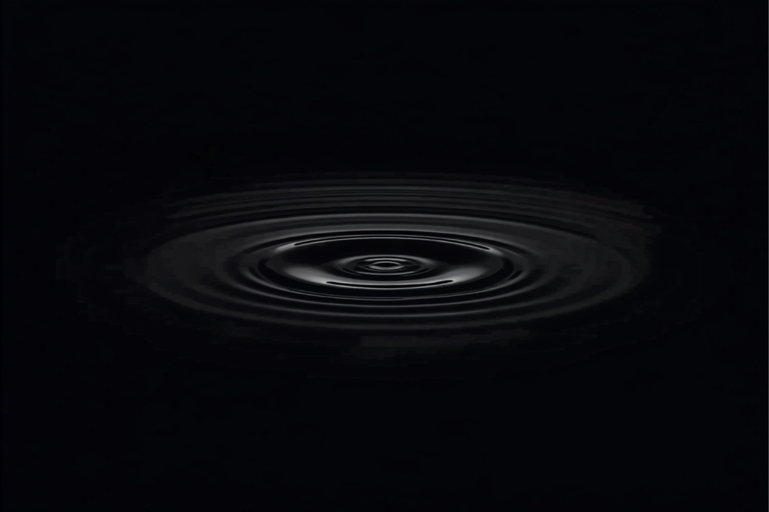 Slow concentric ripples spread across a still black pond with a small gold reflection at the center.