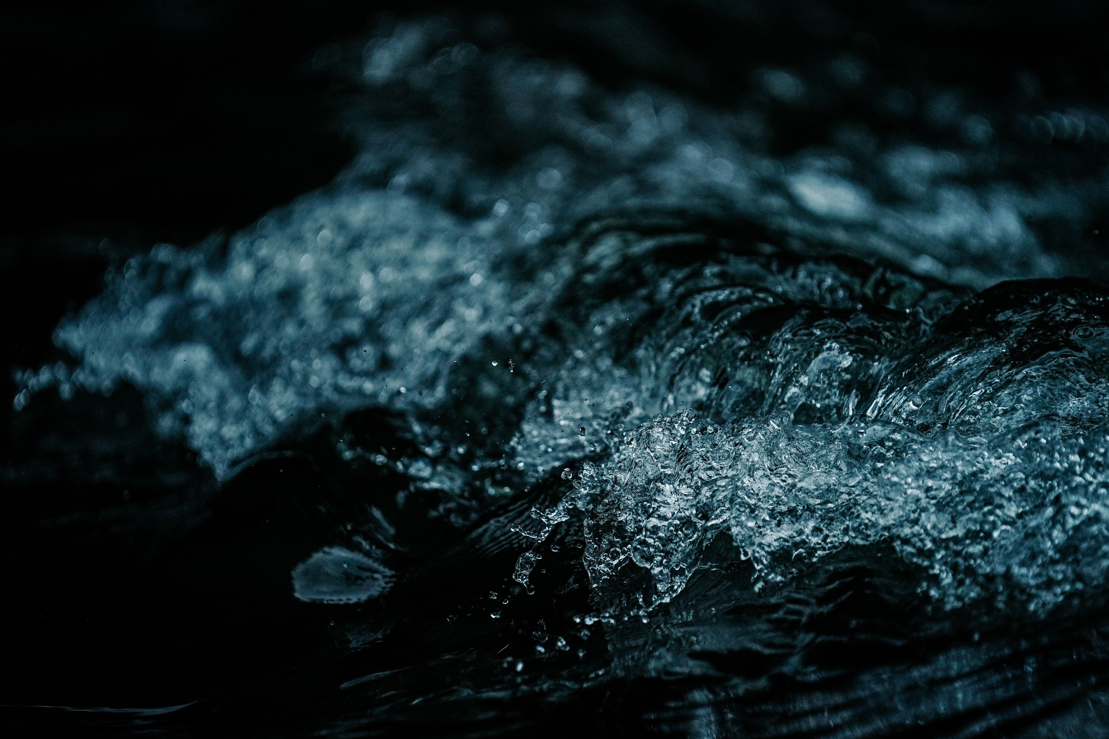 Cold dark water breaking with ice and spray.