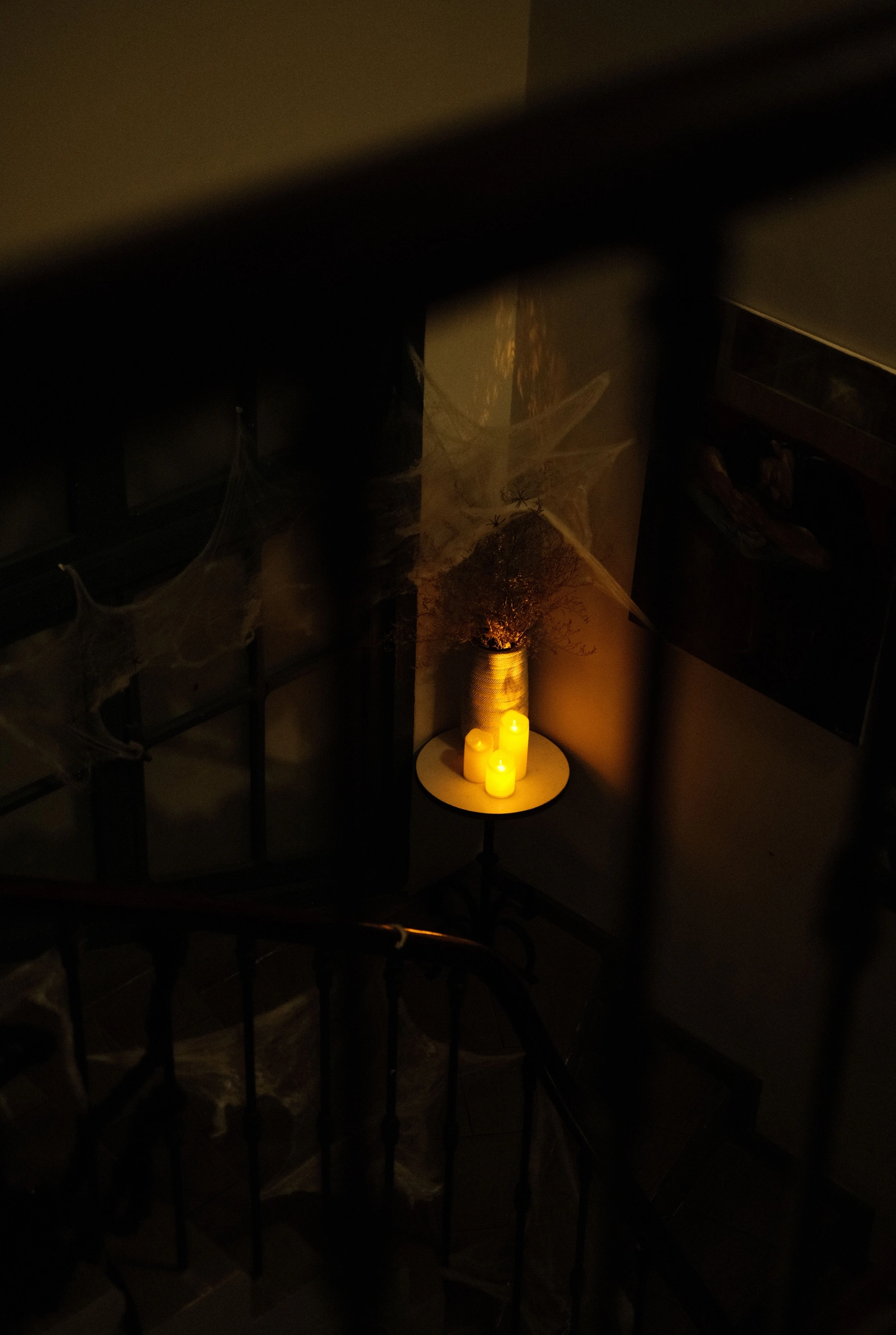 A warm lantern glowing on a dark stairway.