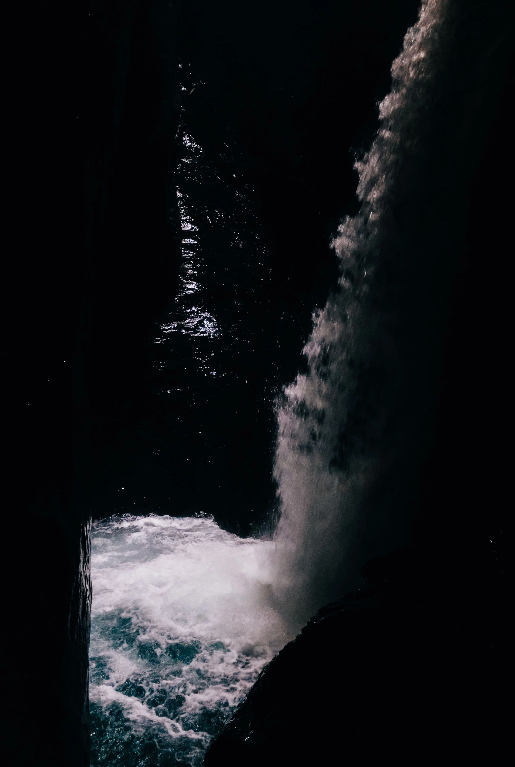 Dark water flowing over stone.