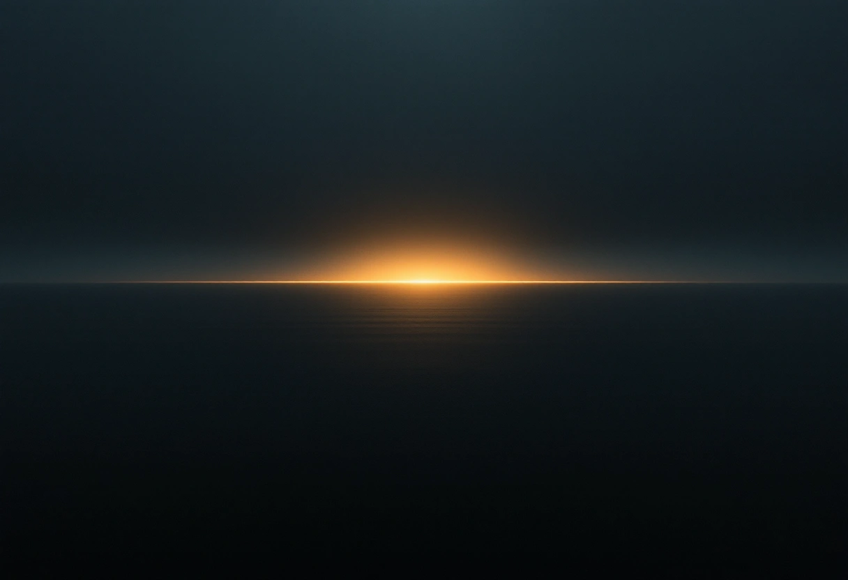 A calm expanse of still dark water with a soft band of golden light across it at dusk.